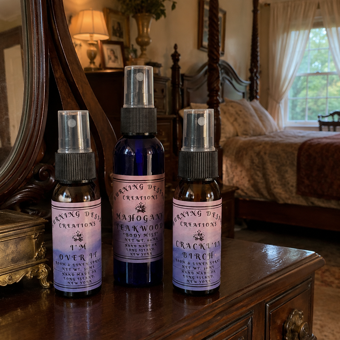 Three Burning Desire spray bottles displayed on a bedroom dresser.